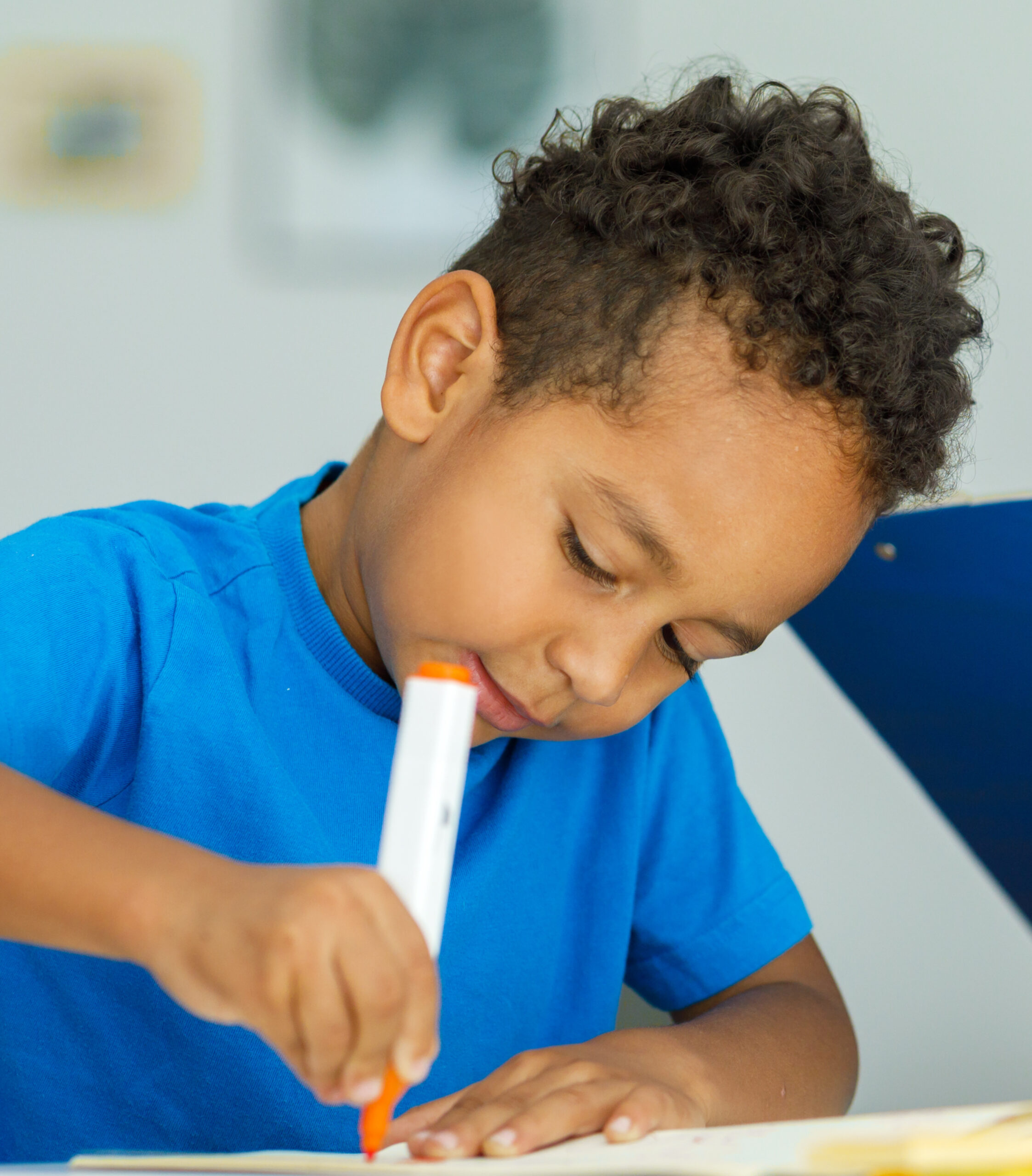 Young child working on holding and using a marker